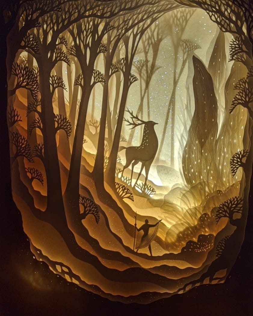 intricate paper cut scenery in frame
