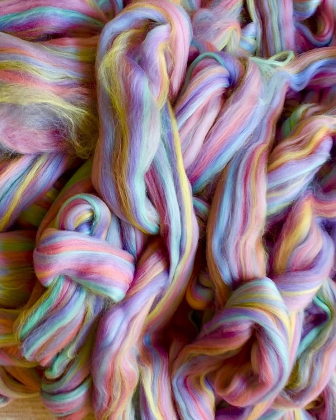 chunky knit blankets draped over a sofa