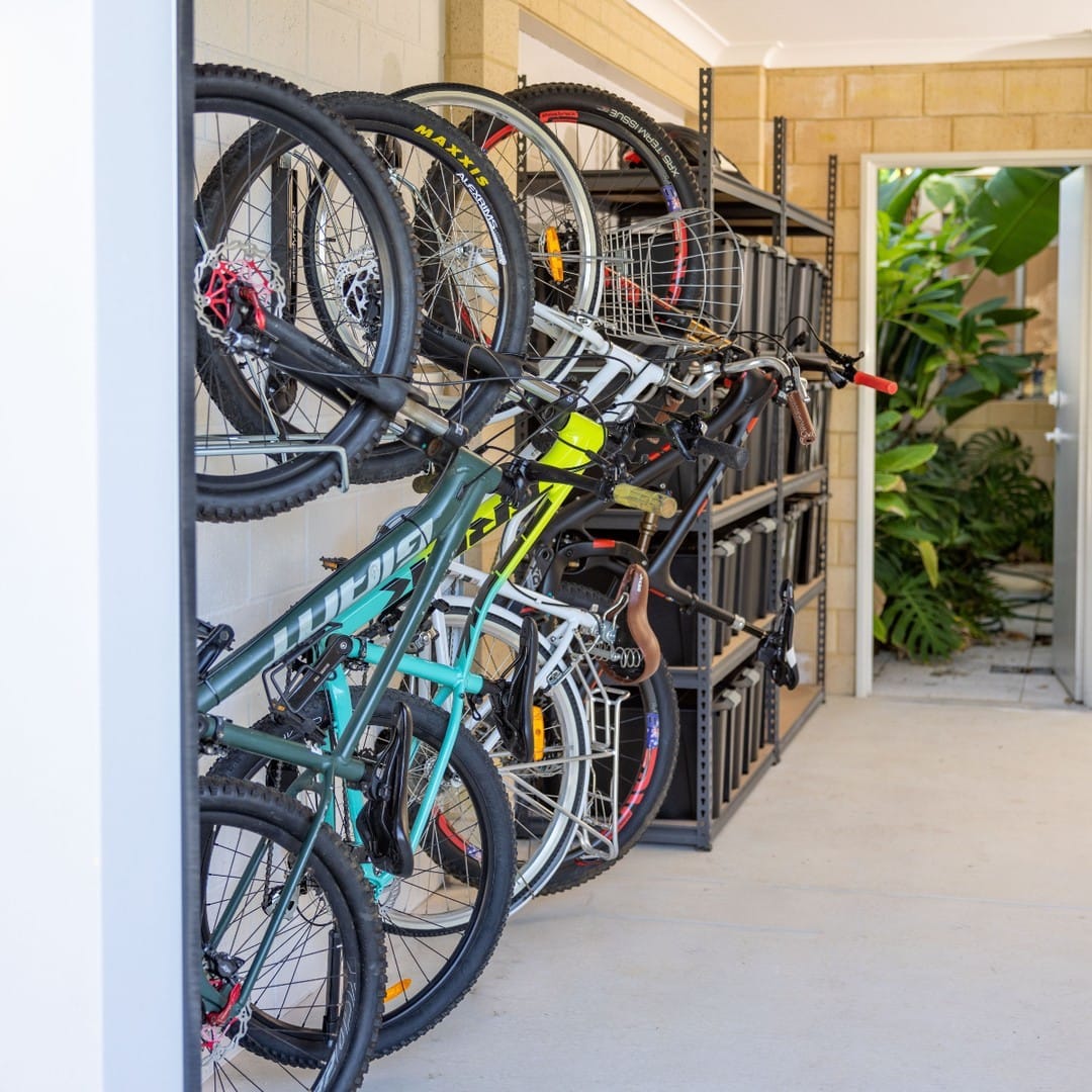 bicycles hanging on wall hooks