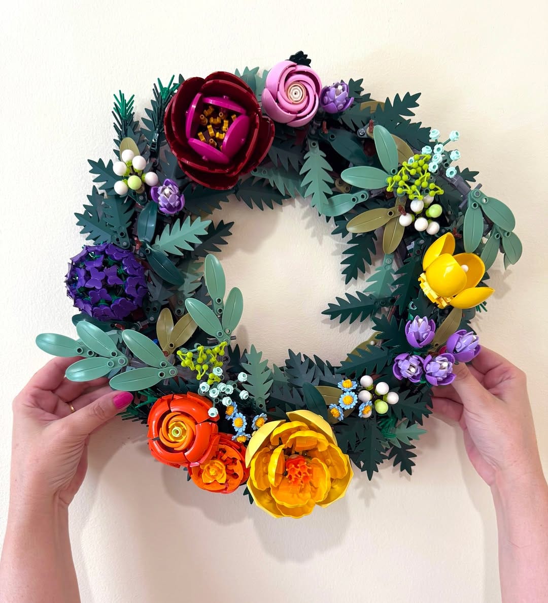 colorful paper flower wreath on door