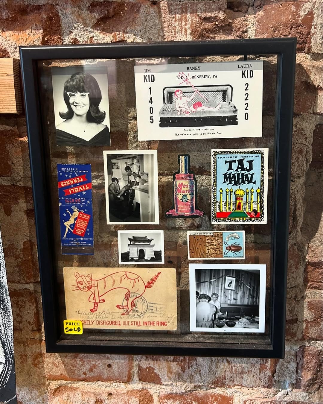 shadow box with travel memorabilia and photos