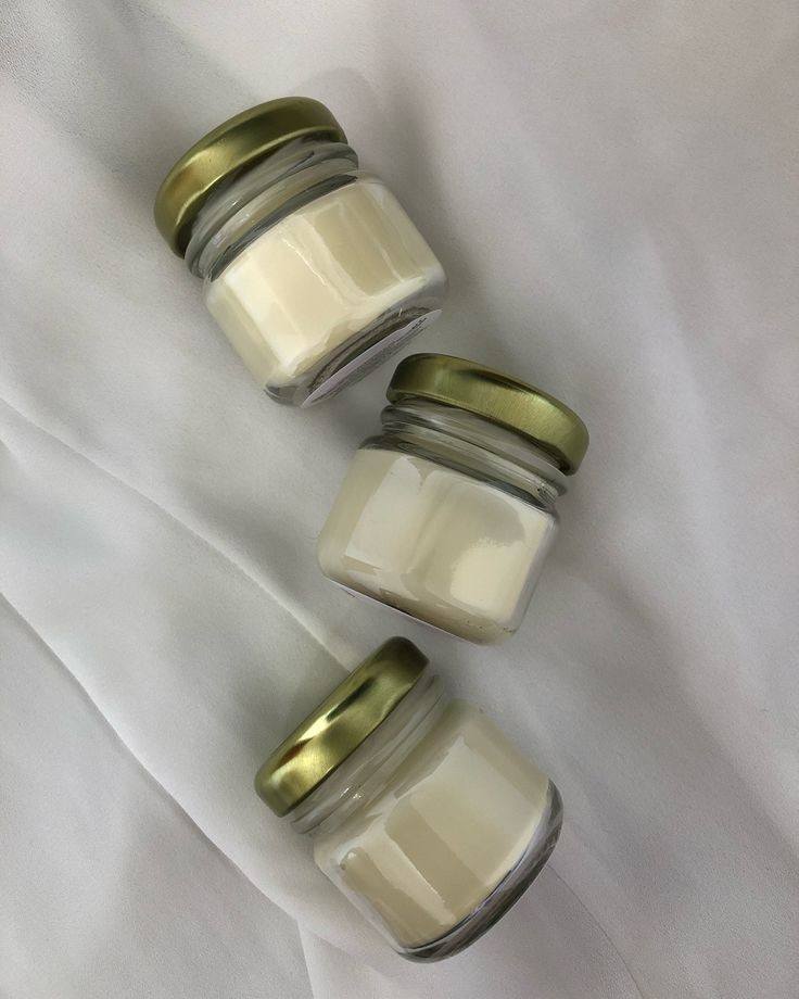 handmade soy candles in decorative glass jars